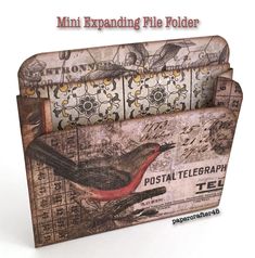 there is a card holder made out of old newspaper paper with a bird on it