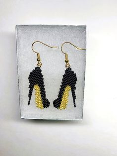 Hand beaded Stiletto earrings, made with glass delica beads and fire line thread. The ear hooks are gold plated and can be worn by anyone with sensitive ears.  Stilettos look awesome with any outfit from jeans to formal attire and these are much easier to wear than real stilettos.  The earrings are very light weight and will come in a silver box tied with a ribbon so you can gift them to someone special or keep them for yourself. To see more beaded jewelry and handmade gifts, please click this l Handmade Moccasins, Leather Baby Moccasins, Paw Print Earrings, Gold High Heels, Red Stilettos, Butterfly Wing Earrings, Silver Box, Wing Earrings, Leather Fringe