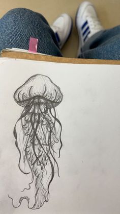 a drawing of a jellyfish is shown in front of someone's legs and feet