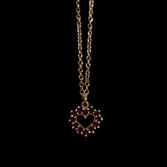 This delicate antique garnet heart necklace features rich, deep red garnets beautifully crafted into a heart shape. The garnets are encased in 14k yellow gold fill settings. The pendant hangs gracefully from a fine gold 14k yellow gold vermeil chain, adding a touch of timeless elegance to any outfit. This piece is not only a stunning example of antique jewelry but also a romantic symbol of enduring love Antique Pendant measures approx. 11mm by 13mm Features 12 approx. 1.5mm round garnets Set on a new 16" 14k yellow gold vermeil chain along with a new lobster clasp Because we do all our restoration work by hand we can offer a huge array of customization! If you have inquiries about sizing, alterations, or engraving, you can inquire about a quote here. As with all antiques, this piece is one Formal Valentine's Day Gold Plated Heart Necklace, Victorian 14k Gold Jewelry For Valentine's Day, Victorian 14k Gold Heart-shaped Jewelry, Victorian 14k Gold Heart Shaped Jewelry, Victorian 14k Gold Heart Jewelry, Gold Double Heart Gemstone Necklaces, Fine Ruby Heart-shaped Jewelry, Fine Ruby Heart Jewelry, Victorian Yellow Gold Jewelry For Valentine's Day