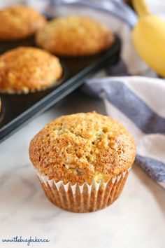 a muffin sitting on top of a counter next to some other muffins