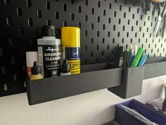 a black shelf with some pens and other items on it