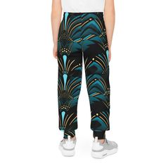 Product Description: Elevate your teen's streetwear game with ourZanzibar Blue & Ebony Black Fashion For Kids Joggers, a versatile addition to their wardrobe that's perfect for various occasions. Whether they're playing sports, lounging at home, or aiming to complete a fresh streetwear look, these joggers have got them covered. Crafted from 95% recycled polyester and 5% spandex, these joggers offer both sustainability and comfort. The medium fabric weight (7.5 oz /yd² (250 g/m²)) strikes the per Teen Streetwear, Kids Jogger, Playing Sports, Ankara Print, Fashion For Kids, Black F, African Ankara, Printed Joggers, Ankara