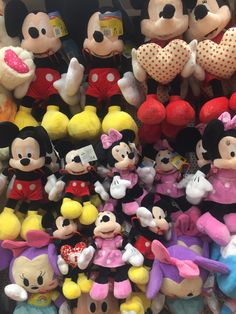 many mickey mouse toys are stacked on top of each other