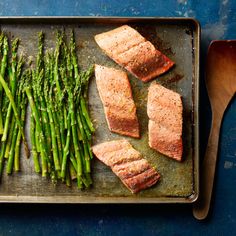 salmon and asparagus on a baking sheet