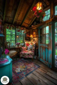 a living room filled with lots of furniture and flowers hanging from the ceiling above it