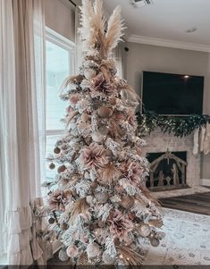 a decorated christmas tree in front of a window