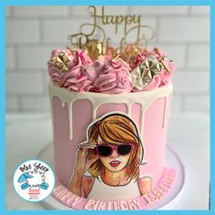 a birthday cake with pink frosting and gold decorations on top, featuring a woman's face