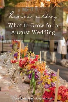 a long table with flowers and candles on it is set up for an outdoor wedding