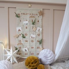 a baby's room decorated in neutral colors with white and gold decorations on the wall