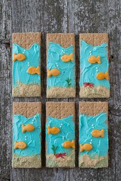 some kind of crackers with blue frosting on them and gold fish in the middle