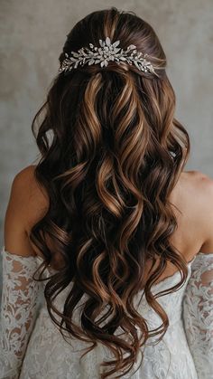 the back of a woman's head with long wavy hair and a tiara