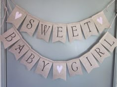 a baby girl banner hanging on the wall