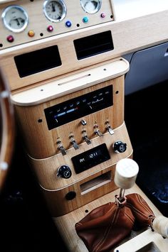 the dashboard of an old car with buttons and gauges