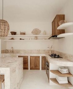 a kitchen filled with lots of counter top space and wooden cabinetry next to an oven