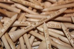 wooden crochet hooks with names and date written on them are shown in close up