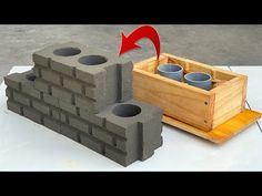 a cement block with two cups in it and an arrow pointing to the brick wall