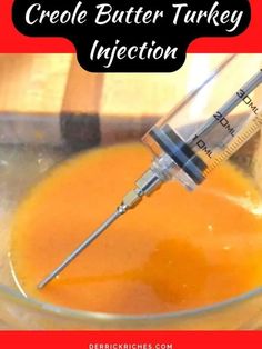 a glass bowl filled with orange liquid and a syringe in the middle that says, how to crochet butter turkey injection