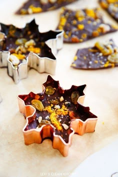 several cookie cutters are arranged on a table with other cookies in the shape of stars