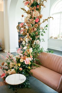 an arrangement of flowers and greenery is on display in the lobby at this wedding venue