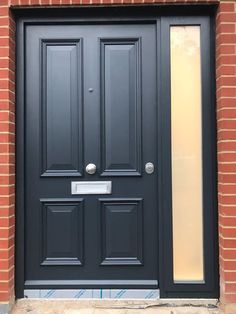 a black front door on a brick building