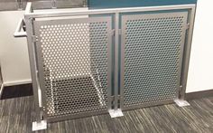 an office cubicle with metal partitions on the floor