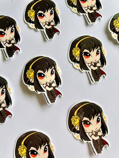 many anime stickers are shown on a white surface, including one with red eyes and the other with black hair