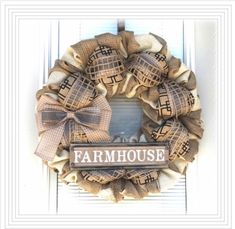 a burlock wreath with the word farmhouse on it