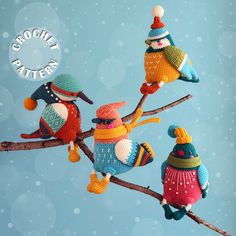 three knitted birds sitting on top of a tree branch