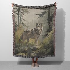 a woman standing in front of a tapestry with a wolf on it's back