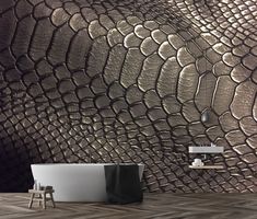 a bath tub sitting next to a wall covered in metallic snakeskind leathers