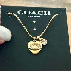 Brand New Without Tags And Absolutely Gorgeous Describes This Authentic Coach Pave Initial “O” Heart With Crystal Accent Charm Pendant Beautifully Displayed On This Genuine 18k/.925 Necklace. Designer Trademark Stamped Coach On The Backside Of The Heart. Necklace Measures 18” In Length. Lobster Claw Clasp. Gold-Toned. *** Please Note - This Necklace Will Ship In A Small Black Velvet Drawstring Dust Bag And Does Not Include The Coach Necklace Card As Seen In Main Picture*** Coach Necklace, Coach Jewelry, Coach New York, Lobster Claw, Heart Necklace, Black Velvet, Charm Pendant, Womens Jewelry Necklace, Dust Bag