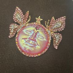 a brooch with an image of a man's face and stars on it