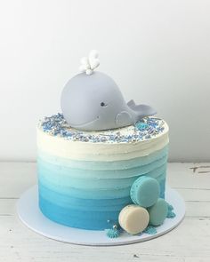 a blue and white cake with a whale on top