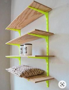 three wooden shelves on the wall, one with a mug and two without ones in it