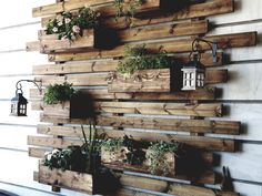 wooden pallet wall with hanging plants and lanterns