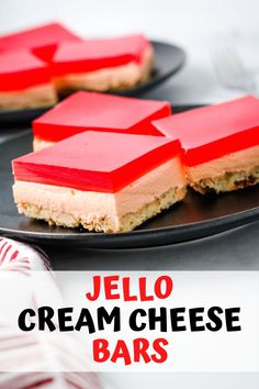 two desserts on black plates with red cream cheese bars in the middle and text overlay that reads jello cream cheese bars