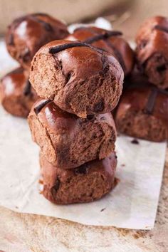 chocolate muffins stacked on top of each other with one broken in the middle