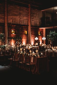 the tables are set up with candles and centerpieces for an elegant wedding reception