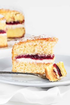 a piece of cake on a white plate with a fork in front of the slice