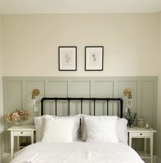 a white bed with two framed pictures above it