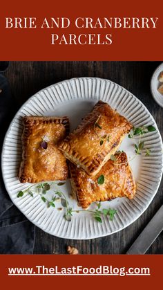 three cranberry pastries on a white plate with the words brie and cranberry parcels