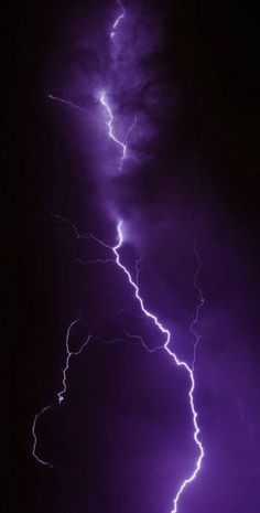 lightning strikes in the night sky with purple hues