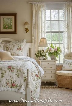 a white bed sitting next to a window in a bedroom