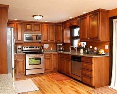 a kitchen with wooden cabinets and stainless steel appliances