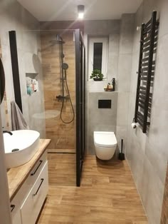 a bathroom with a toilet, sink and shower stall in it's own area