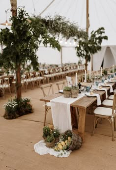 an outdoor tent set up with tables and chairs