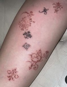 a woman's arm with four different designs on the left side of her arm