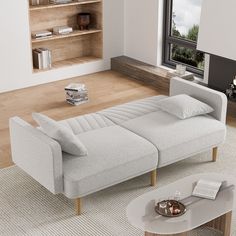 a living room with a couch, coffee table and bookshelf in the corner