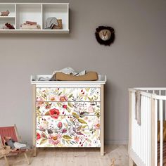 a baby's room with a dresser and crib